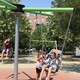 Children playing on a swing roundabout 